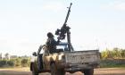 A Free Syrian Army fighter aims his weapon towards a Syrian military warplane. (Reuters)