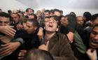 Palestinian relatives and friends mourn over the death of Arafat Jaradat, who died in an Israeli prison, after his body was handed over by Israeli authorities on February 24, 2013 at a hospital in the West Bank city of Hebron. (AFP)