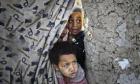 Internally displaced Afghan children wait for winter relief assistance from the UN refugee agency at a camp in Kabul. (Photo: Musadeq Sadeq/AP)
