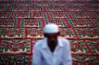 A man prays outside a mosque in Banda Aceh December 5, 2012. Aceh is Indonesia’s only province to have implemented Shariah, or Islamic laws. (Reuters Photo/Damir Sagolj)