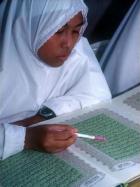 A Muslim girl studies the Koran at a Brunei school. The code is to be applied only to Muslims