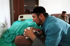 Islamic healer Timur Chamaev places his hands on a patient and recites from the Koran during treatment in the Islamic Medical Centre in the Chechen capital Grozny July 20, 2011. Credit: Reuters/Stringer