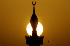 The sun sets behind a minaret in the center of Riyadh March 1, 2008. (Ali Jarekji/Reuters)