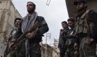 Free Syrian Army fighters carry their weapons as they stand on a street in Aleppo's al-Amereya district December 11, 2012. (Photo: Reuters/Aaref Hretani)