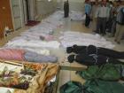 Victims of war: The bodies of people whom anti-government protesters say were killed by security forces in Houla, near Homs, yesterday. (Reuters)
